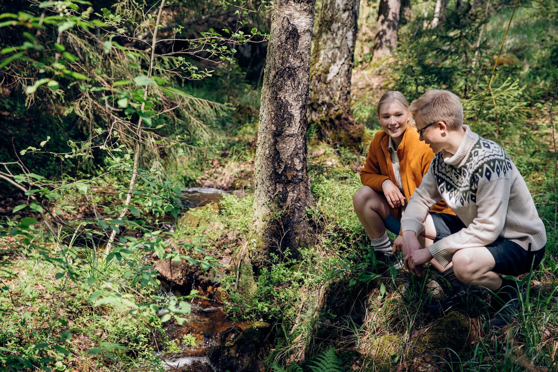 RFI brand photoshoot in Espoo, Finland. Two Environmental Specialists by a stream in Nuuksio National Park, Finland.