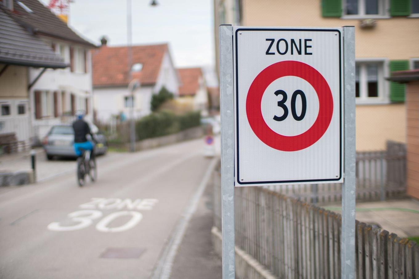 30 km/h zone sign on the side of a city street