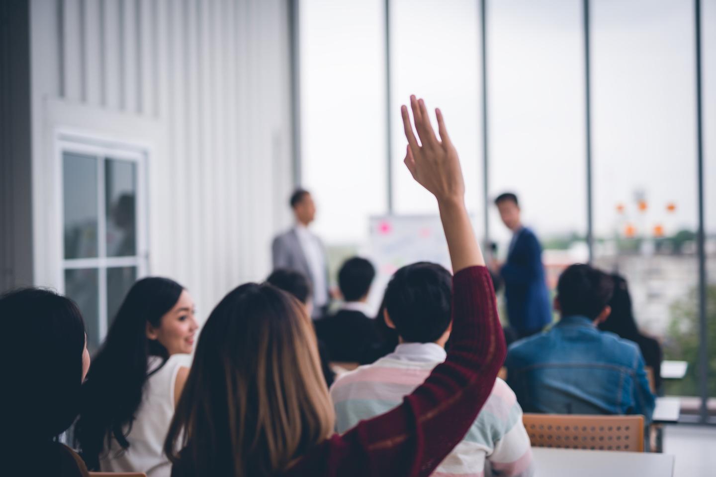 Woman asking question at meeting