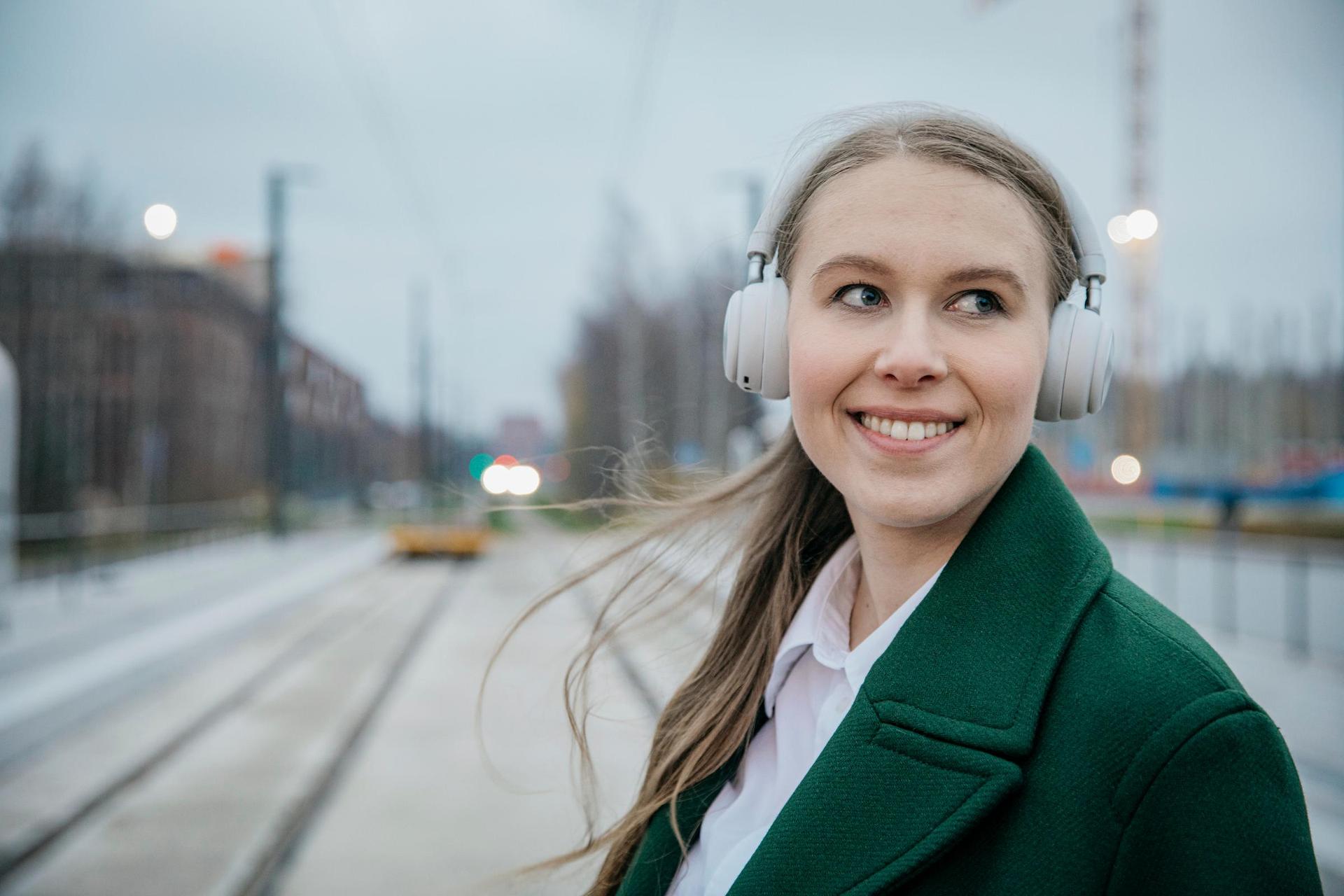 RFI brand picture photoshoot in Espoo, Finland. Taken in October 2021. In the picture a woman is holding a Ramboll umbrella and posing for the camera.