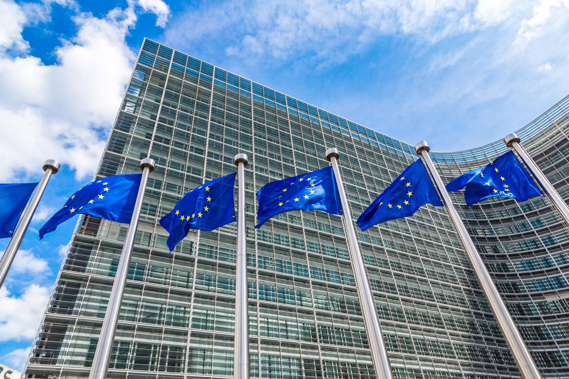 European flags in front of  headquarters of European commission in Brussels in summer day