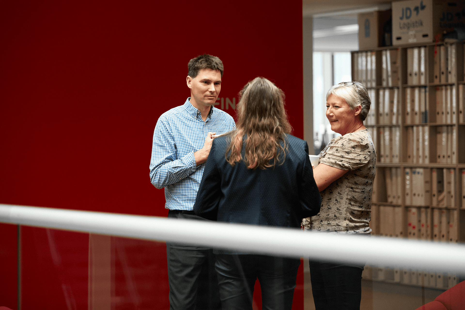 Ramboll employees talking in the office hallway