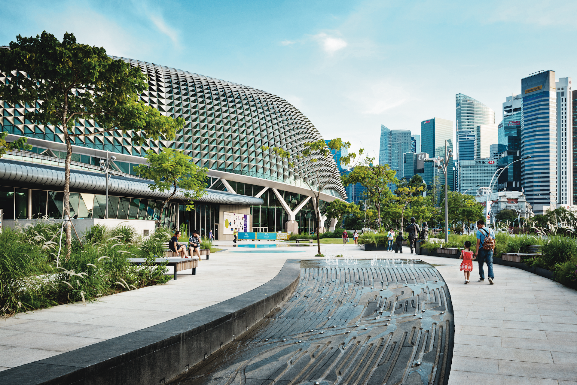 People walking past water landscape design at Esplanade Court Garden in Singapore