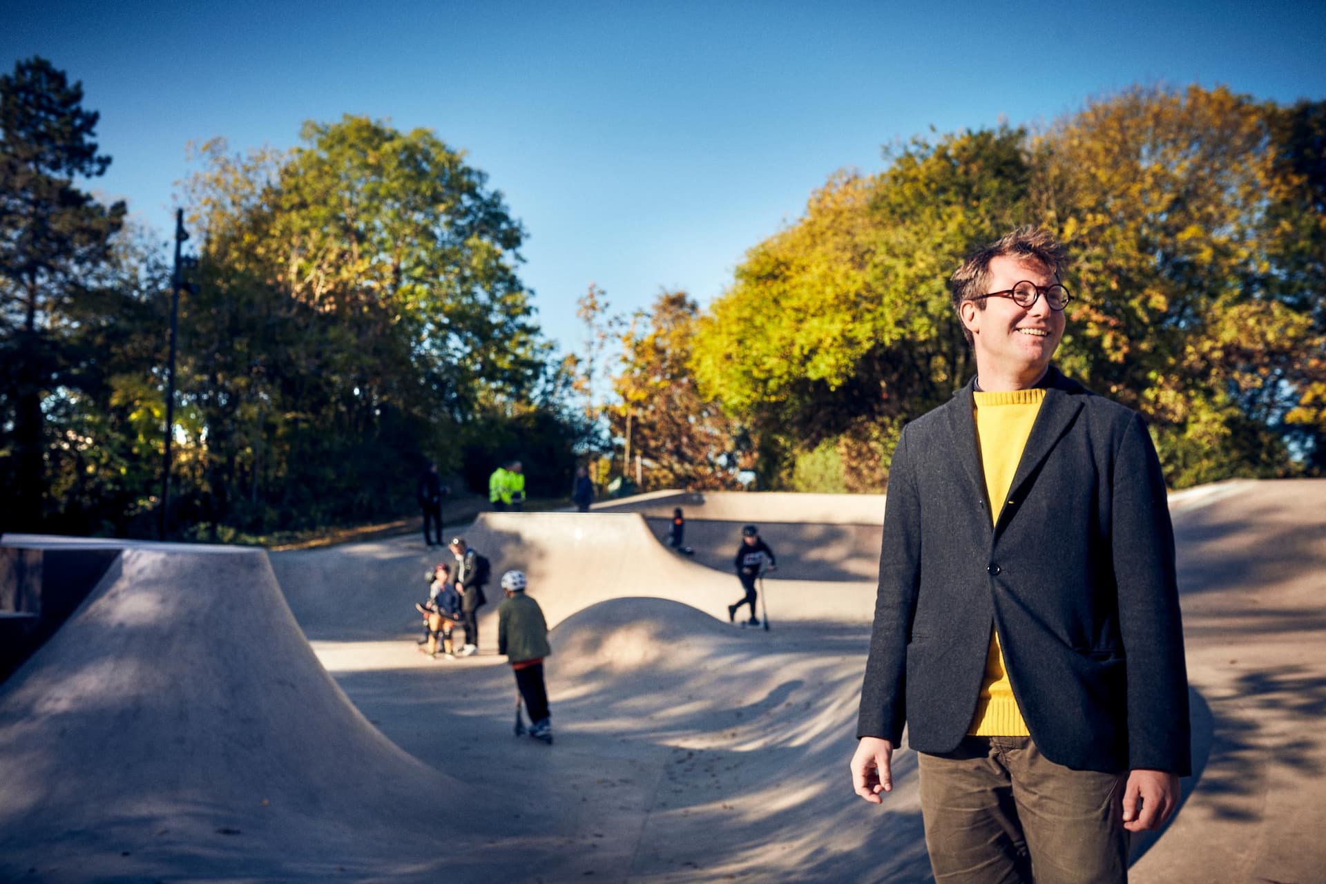 Man with a skateboard park in the background