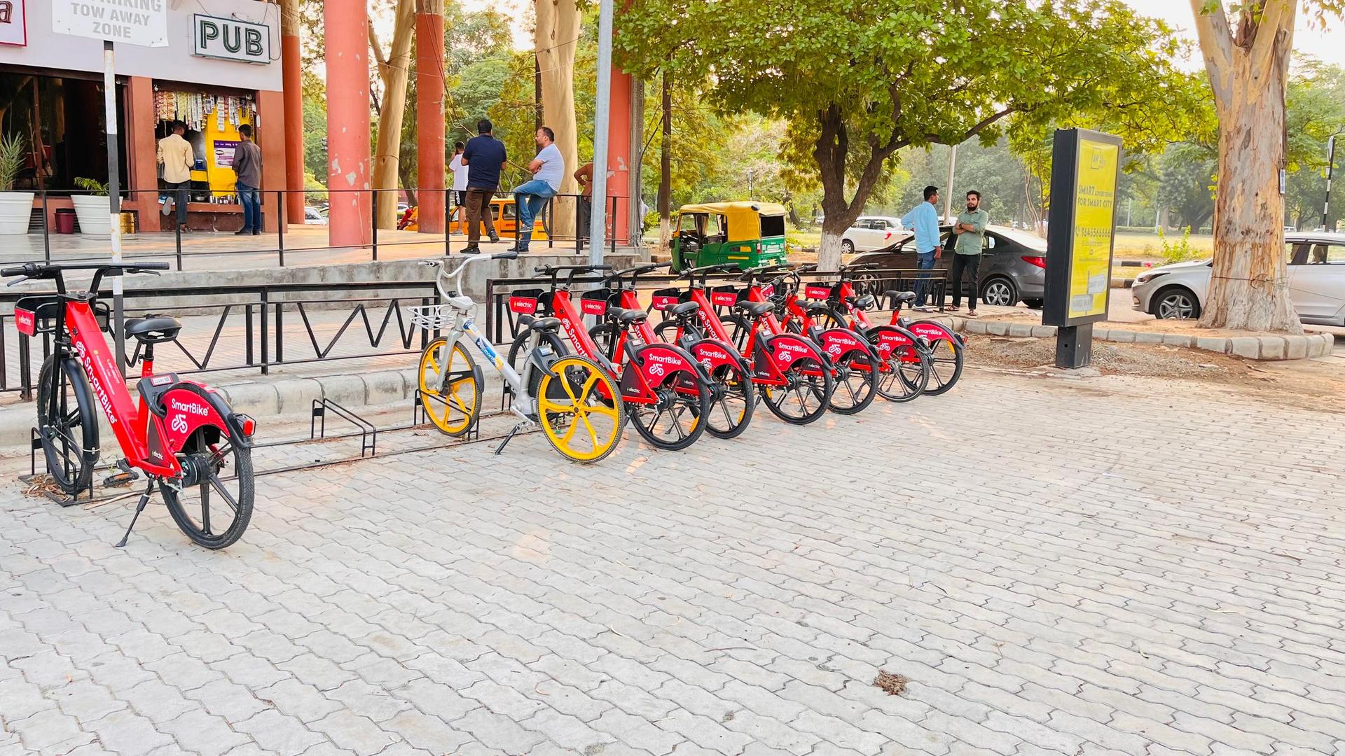 E-bikes parked on a pavement in city in India