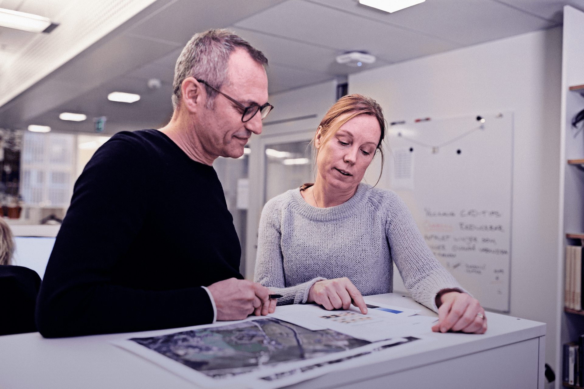 Two people having a meeting, standing, Stockholm office Sweden